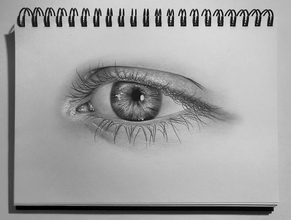 A well drawn, realistic image of an eye rendered in pencil.